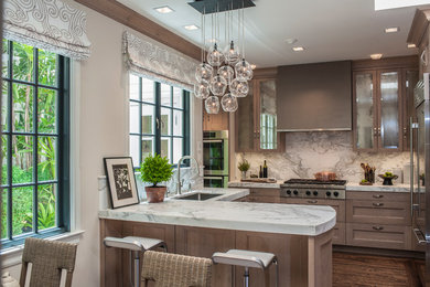 Example of a large transitional l-shaped dark wood floor and brown floor eat-in kitchen design in San Francisco with a drop-in sink, recessed-panel cabinets, medium tone wood cabinets, marble countertops, gray backsplash, marble backsplash, stainless steel appliances and an island
