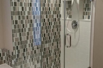 Bathroom - mid-sized transitional master black tile, brown tile, white tile and glass sheet porcelain tile and brown floor bathroom idea in Philadelphia with brown walls and a hinged shower door
