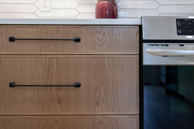 Example of a small trendy galley enclosed kitchen design in Other with an undermount sink, shaker cabinets, white cabinets, quartz countertops, white backsplash, porcelain backsplash, stainless steel appliances, no island and white countertops