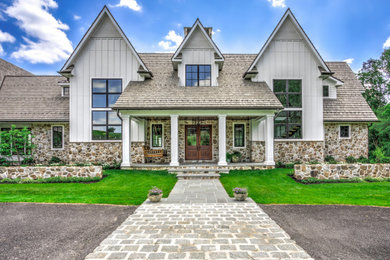 Example of a huge transitional white two-story concrete fiberboard and board and batten house exterior design with a tile roof and a gray roof