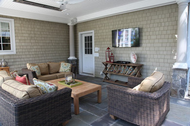 Example of a mid-sized classic backyard concrete patio kitchen design in New York with a roof extension