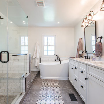 Bathroom remodeled in Rockville, MD with double vanity, glass shower & bathtub