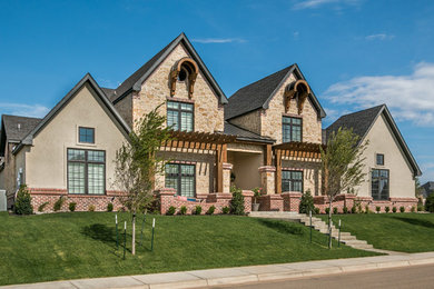 Large transitional multicolored two-story stucco exterior home idea in Dallas with a shingle roof