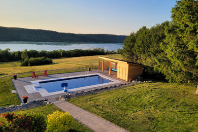 Inspiration for a backyard concrete paver and rectangular pool house remodel in Other