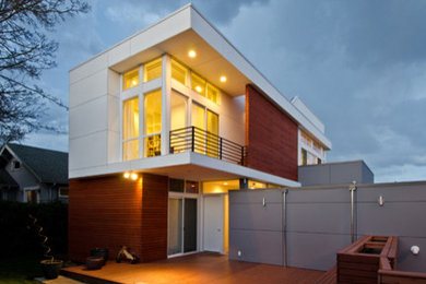 Mid-sized minimalist backyard deck photo in Seattle with a roof extension