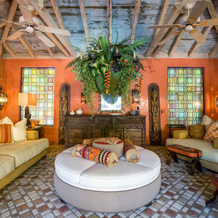 Großes Mediterranes Wohnzimmer mit Terrakottaboden, oranger Wandfarbe und buntem Boden in Miami