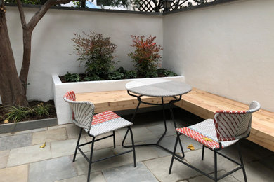 Inspiration for a small modern courtyard stone patio remodel in Philadelphia