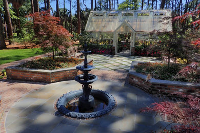 Photo of a traditional partial sun garden in Other with with raised garden bed and brick pavers.