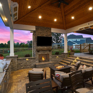 Pavilion with outdoor kitchen, gas fireplace and swim up bar.