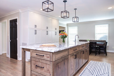Eat-in kitchen - mid-sized country l-shaped medium tone wood floor and brown floor eat-in kitchen idea in Raleigh with shaker cabinets, white cabinets, granite countertops, an island and white countertops