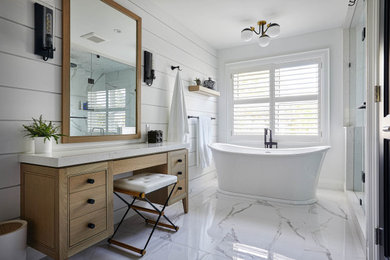 Example of a mid-sized transitional master porcelain tile, white floor and shiplap wall freestanding bathtub design in Toronto with furniture-like cabinets, light wood cabinets, white walls and a built-in vanity