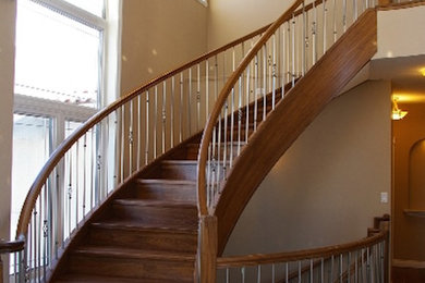 Example of a mid-sized classic wooden curved wood railing staircase design in Other with wooden risers