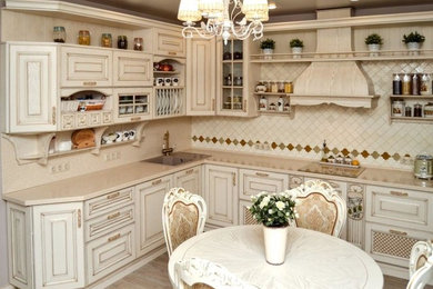 Design ideas for a small asian l-shaped separate kitchen in Yekaterinburg with an undermount sink, raised-panel cabinets, beige cabinets, solid surface benchtops, beige splashback, mosaic tile splashback, white appliances, ceramic floors, no island, brown floor and beige benchtop.