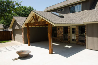 Immagine di un grande patio o portico chic davanti casa con lastre di cemento, un gazebo o capanno e un focolare