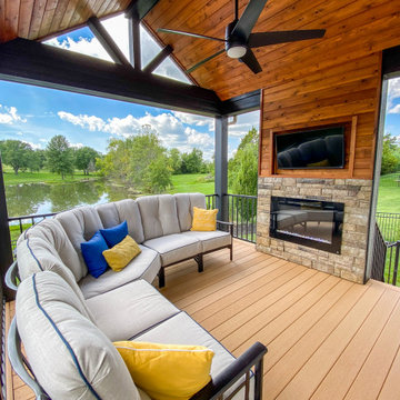 Covered Deck with a Fireplace Wall and Bar Area