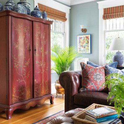 Family room - mid-sized traditional enclosed light wood floor and coffered ceiling family room idea with blue walls, no fireplace and a media wall