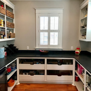 Mid-sized craftsman kitchen pantry ideas - Mid-sized arts and crafts u-shaped medium tone wood floor kitchen pantry photo in Jackson with open cabinets, white cabinets and soapstone countertops