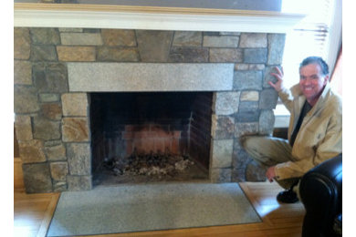 Traditional living room in Boston with a standard fireplace and a stone fireplace surround.