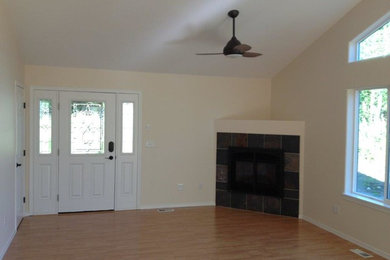 Inspiration for a mid-sized timeless open concept light wood floor living room remodel in Other with beige walls, a corner fireplace and a tile fireplace