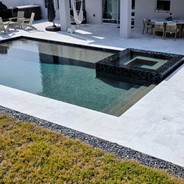 St. Cloud pool with overflow perimeter spa and sun shelf