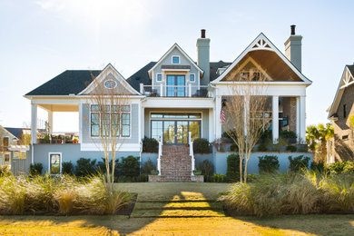 Coastal gray two-story shingle exterior home idea in Charleston with a shingle roof and a black roof