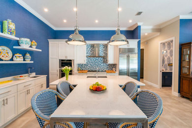 Inspiration for a large transitional vinyl floor and gray floor open concept kitchen remodel in Other with an undermount sink, shaker cabinets, white cabinets, quartz countertops, blue backsplash, mosaic tile backsplash, stainless steel appliances, an island and white countertops