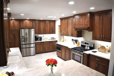 Kitchen pantry - transitional porcelain tile kitchen pantry idea in Other with an undermount sink, raised-panel cabinets, medium tone wood cabinets, granite countertops and glass tile backsplash