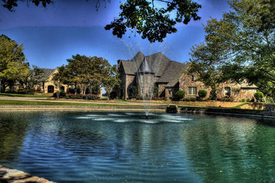 Example of a classic two-story mixed siding exterior home design in Dallas with a hip roof