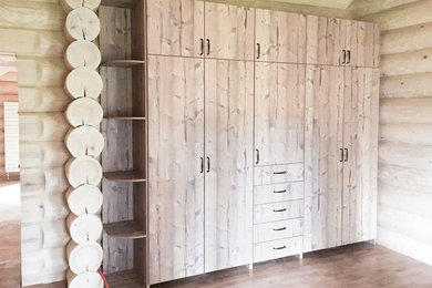Inspiration for a large farmhouse gender neutral standard wardrobe in Saint Petersburg with flat-panel cabinets and distressed cabinets.