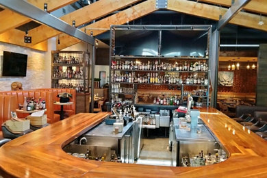 Example of an arts and crafts home bar design in Dallas