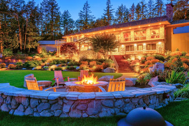 Design ideas for a mid-sized rustic full sun backyard formal garden in Portland with a fire pit for fall.