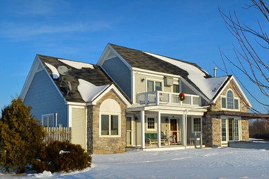 Large beige two-story mixed siding exterior home photo in Burlington with a hip roof