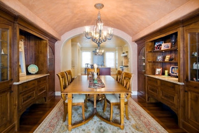 Inspiration for a large mediterranean separate dining room in Milwaukee with beige walls, dark hardwood floors and no fireplace.