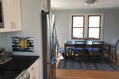 Inspiration for a large modern medium tone wood floor kitchen/dining room combo remodel in Providence with gray walls