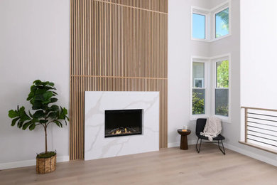 Danish vinyl floor and brown floor living room photo in Orange County with a stone fireplace