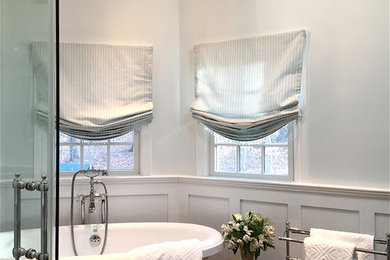 Example of a large classic master blue tile and ceramic tile porcelain tile and brown floor bathroom design in Other with raised-panel cabinets, blue cabinets, a one-piece toilet, blue walls, an undermount sink, marble countertops and a hinged shower door
