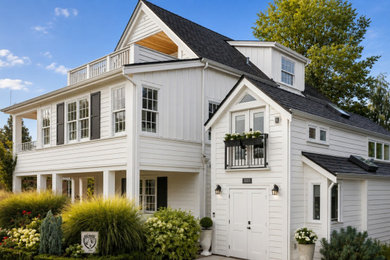 Small traditional wood and board and batten tiny house idea in Seattle with a shingle roof and a black roof