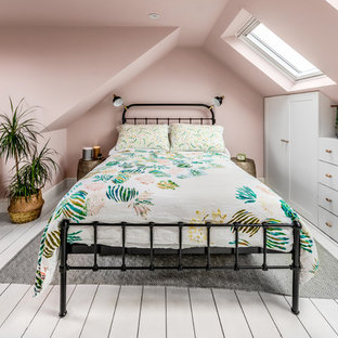 Inspiration for a small transitional bedroom in Surrey with pink walls, painted wood floors and white floor.