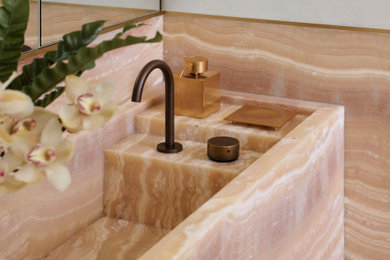 Design ideas for a large contemporary master bathroom in Sydney with onyx benchtops.