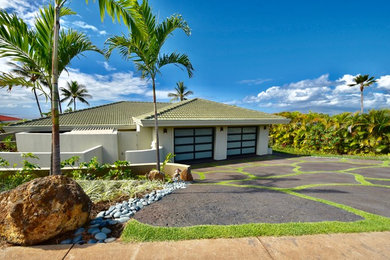 Inspiration for a large tropical white two-story stucco gable roof remodel in Hawaii