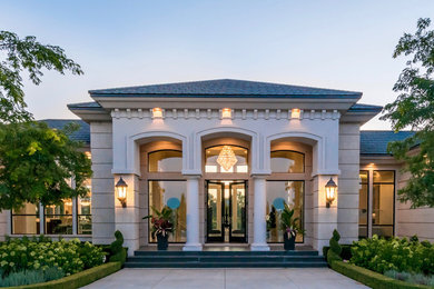 Inspiration for a large transitional white two-story mixed siding house exterior remodel in Orlando with a hip roof and a shingle roof