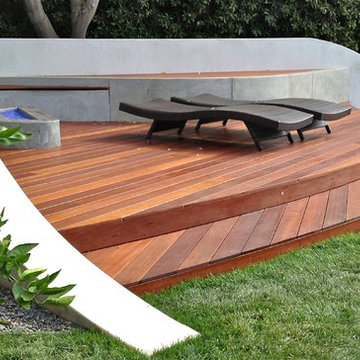 Mangaris Hardwood Wave Deck with built in blue glass fire pit.