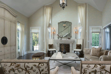 This is an example of a large transitional formal enclosed living room in Chicago with beige walls, dark hardwood floors, a standard fireplace, a wood fireplace surround, no tv and brown floor.