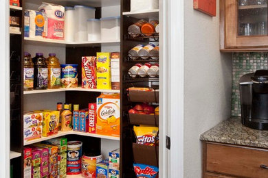 This is an example of a small traditional kitchen pantry in Los Angeles with white cabinets.