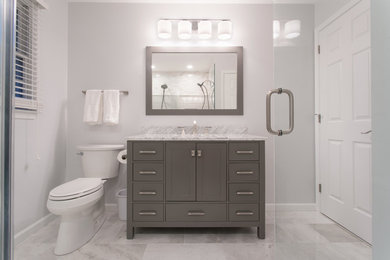 Double shower - mid-sized contemporary master gray tile and subway tile marble floor double shower idea in Philadelphia with shaker cabinets, gray cabinets, a two-piece toilet, gray walls, an undermount sink and marble countertops
