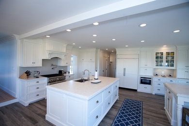 Eat-in kitchen - large traditional l-shaped eat-in kitchen idea in Other with quartzite countertops, stainless steel appliances, two islands and beaded inset cabinets