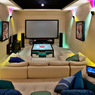 Trendy enclosed carpeted and beige floor home theater photo in Hawaii with yellow walls and a wall-mounted tv