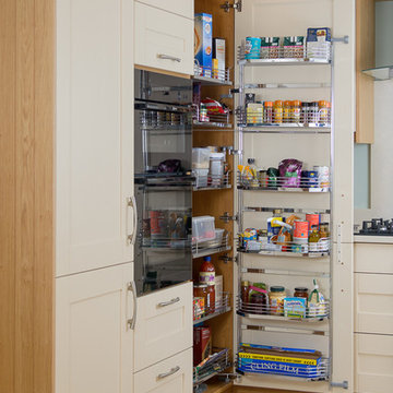 An exiting traditional kitchen with cream Shaker doors and light wood trimmings