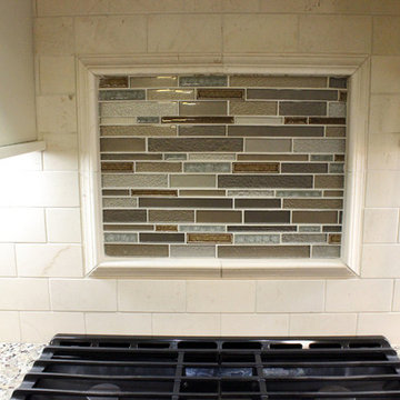 Beige Kitchen with Extra Large Island, Tile Backsplash and Granite Countertops