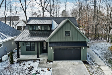 Mid-sized transitional green two-story concrete fiberboard and clapboard house exterior photo in Cincinnati with a shed roof, a mixed material roof and a black roof